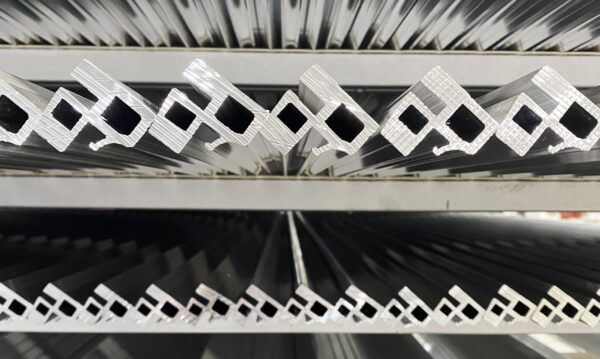 Stacked aluminum pieces showing end view of the shapes.