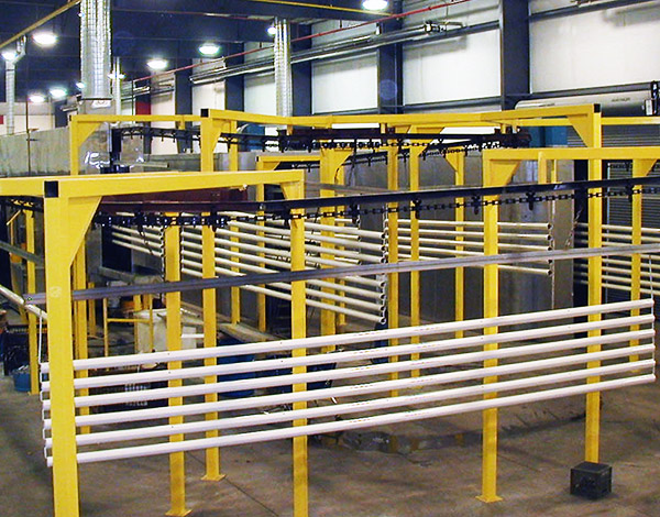 Aluminum extrusions hanging in the powder coating/anodizing finishing line to dry.