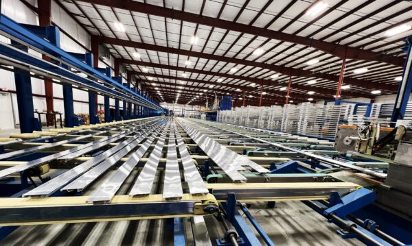 Wide angle view of Star's newest press line with long aluminum extrusion pieces on it.