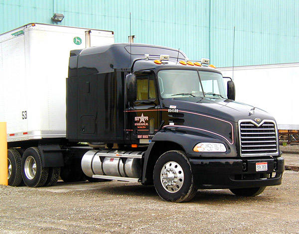 Star Extruded Shapes black delivery semi truck.