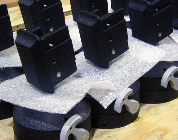 Black lined up products with foam pieces to ensure safe packing and shipping.