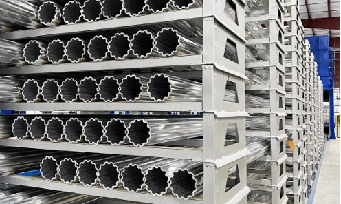Shelves of long extruded aluminum are lined up at the warehouse.